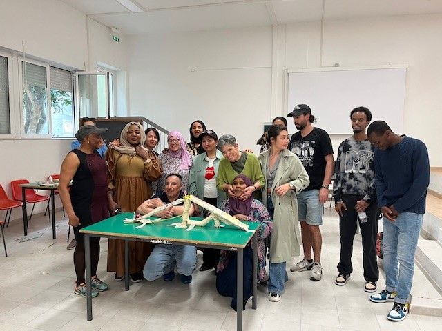 en gruppe mennesker som står rundt et bord og bygger bro