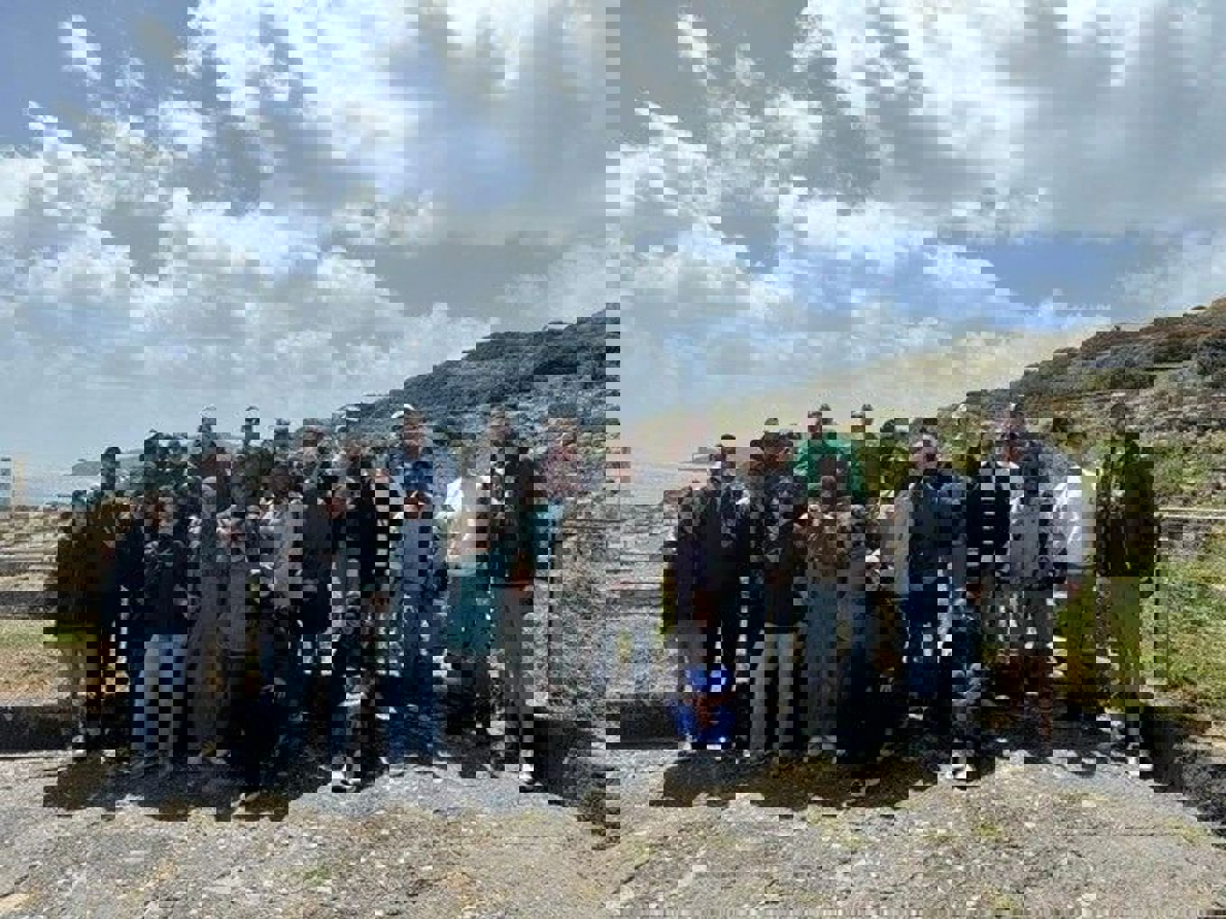 Foto: Gruppebilde fra Tharros En gruppe mennesker som poserer for et bilde, utsikt til havet