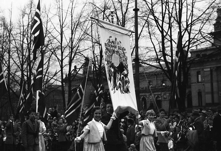 Skolefanen oppover Karl Johan på 17. mai, trolig ca 1956.  Skolefanen oppover Karl Johan på 17. mai, trolig ca 1956.