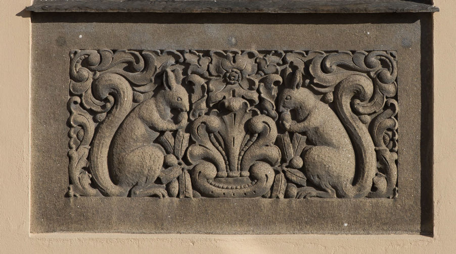 Foto: Ekorn som spiser nøtter. Detalj fra yttervegg. Detaljbilde av Dynekilgata 10, der det er en utskjæring av to ekorn.